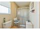 Bathroom with a walk-in shower and a chair, designed for accessibility and comfort at 2382 Due West Dr, The Villages, FL 32162