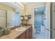 Bathroom featuring a large mirror, vanity with lamps, with an open door to the shower and toilet at 2382 Due West Dr, The Villages, FL 32162