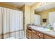 Bathroom with a shower and tub combination, vanity with a sink, and a woven cabinet for storage at 2382 Due West Dr, The Villages, FL 32162
