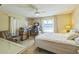 Bright primary bedroom with a ceiling fan, with sliding glass doors leading to the lanai at 2382 Due West Dr, The Villages, FL 32162