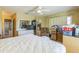 Large bedroom featuring a ceiling fan, a comfortable chair, and filled with personal items at 2382 Due West Dr, The Villages, FL 32162