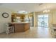 Spacious kitchen with modern appliances, ample counter space, and sliding doors leading to an outdoor dining area at 2382 Due West Dr, The Villages, FL 32162