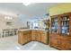 Open kitchen with tile flooring, wood cabinetry, and a functional center island perfect for meal preparation and casual dining at 2382 Due West Dr, The Villages, FL 32162