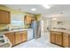 Bright kitchen featuring stainless steel appliances, ample counter space, and tile floors, creating a clean and efficient cooking area at 2382 Due West Dr, The Villages, FL 32162