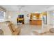 Open-concept living room seamlessly connected to the kitchen, featuring tile floors and abundant natural light at 2382 Due West Dr, The Villages, FL 32162