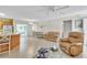 Inviting living area with tile floors, comfortable seating, and sliding glass doors providing access to the outdoor space at 2382 Due West Dr, The Villages, FL 32162