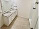 Bathroom with double sink vanity, granite countertop, and a walk-in shower at 5216 Greenheart Ave, Mount Dora, FL 32757