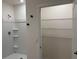 Bathroom with walk-in shower and shelving next to the doorway at 5216 Greenheart Ave, Mount Dora, FL 32757