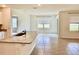 Bright and airy kitchen and dining area with granite countertops and tile flooring at 5216 Greenheart Ave, Mount Dora, FL 32757