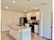 Well-equipped kitchen with stainless steel appliances, granite counters and white cabinets at 5216 Greenheart Ave, Mount Dora, FL 32757
