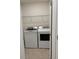 Dedicated laundry room with modern washer, dryer and shelving at 5216 Greenheart Ave, Mount Dora, FL 32757