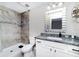 Modern bathroom with a tiled shower and granite countertop at 13257 Sw 29Th Cir, Ocala, FL 34473