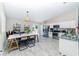 Open-concept dining area with tiled floors, modern lighting, and stainless steel appliances, perfect for entertaining at 13257 Sw 29Th Cir, Ocala, FL 34473
