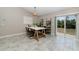 Contemporary dining area with tiled floors, modern lighting, and sliding glass doors leading to the backyard at 13257 Sw 29Th Cir, Ocala, FL 34473