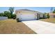 View of the exterior featuring a two-car garage and a concrete driveway at 13257 Sw 29Th Cir, Ocala, FL 34473