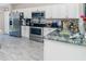 Modern kitchen featuring stainless steel appliances, white cabinets, and granite countertops at 13257 Sw 29Th Cir, Ocala, FL 34473
