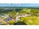Beautiful aerial view of a community clubhouse with pool, surrounded by meticulously landscaped grounds, golf course, and a pond at 3153 Legends Preserve Dr, Daytona Beach, FL 32124