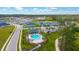 Aerial view showcases a community pool with charming cabana surrounded by lush landscaping and well-maintained sidewalks at 3153 Legends Preserve Dr, Daytona Beach, FL 32124