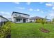 The backyard offers a green lawn ideal for relaxation and recreation at 3153 Legends Preserve Dr, Daytona Beach, FL 32124