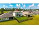 Aerial view of a well-maintained backyard with green grass, a small tree, and a black metal fence at 3153 Legends Preserve Dr, Daytona Beach, FL 32124