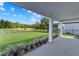 Inviting covered patio overlooking a lush, green backyard with landscaping, perfect for outdoor enjoyment at 3153 Legends Preserve Dr, Daytona Beach, FL 32124