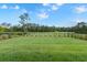 Well-maintained backyard with a manicured lawn, landscaping, and serene views of the surrounding golf course at 3153 Legends Preserve Dr, Daytona Beach, FL 32124