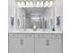 Bright bathroom featuring a double sink vanity, large mirror, and modern fixtures at 3153 Legends Preserve Dr, Daytona Beach, FL 32124