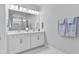 Bathroom with a double sink vanity, contemporary lighting, and a sleek, modern design at 3153 Legends Preserve Dr, Daytona Beach, FL 32124