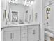 Bright bathroom with double vanity, large mirror, and tiled shower with curtain at 3153 Legends Preserve Dr, Daytona Beach, FL 32124