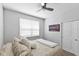 Bedroom with a wall-mounted TV, plush pillows, a window, and a cozy ambiance at 3153 Legends Preserve Dr, Daytona Beach, FL 32124