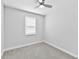 An empty bedroom with neutral carpet, a ceiling fan, and a window at 3153 Legends Preserve Dr, Daytona Beach, FL 32124