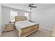 Serene bedroom featuring a large bed, neutral color scheme, and ample natural light from dual windows at 3153 Legends Preserve Dr, Daytona Beach, FL 32124