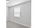 A bright and empty bedroom with neutral gray carpet and a window at 3153 Legends Preserve Dr, Daytona Beach, FL 32124