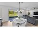 Bright dining area with a stylish chandelier, white round table and views of the well-manicured backyard at 3153 Legends Preserve Dr, Daytona Beach, FL 32124