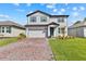 Charming two-story home with a brick driveway and well-maintained landscaping at 3153 Legends Preserve Dr, Daytona Beach, FL 32124