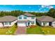 Beautiful two-story home with brick driveway, manicured lawn, and vibrant blue shutters at 3153 Legends Preserve Dr, Daytona Beach, FL 32124