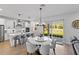 Modern eat-in kitchen with white cabinets and a large sliding glass door to backyard at 3153 Legends Preserve Dr, Daytona Beach, FL 32124