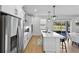Modern kitchen with a large island, stainless steel appliances, white cabinets, and an open view of the dining area at 3153 Legends Preserve Dr, Daytona Beach, FL 32124