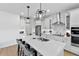 Modern kitchen with a large island, stainless steel appliances, white cabinets, and stylish pendant lighting at 3153 Legends Preserve Dr, Daytona Beach, FL 32124