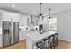 Modern kitchen with white cabinets, stainless steel appliances, granite countertops, and a large island with seating at 3153 Legends Preserve Dr, Daytona Beach, FL 32124