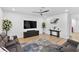 Spacious living room with modern decor, including a large flat-screen TV and a stylish area rug at 3153 Legends Preserve Dr, Daytona Beach, FL 32124