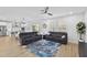 Bright living room boasts wood floors, neutral walls, and modern furniture flowing into a stylish open kitchen at 3153 Legends Preserve Dr, Daytona Beach, FL 32124