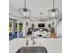 Bright open concept kitchen and living area with a sink island and sliding glass doors to a lanai at 3153 Legends Preserve Dr, Daytona Beach, FL 32124
