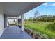 Covered patio offers serene views of the lush, green backyard extending to a peaceful pond at 3153 Legends Preserve Dr, Daytona Beach, FL 32124