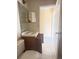 Bathroom with a single vanity, mirror, and tile flooring at 323 Miami Ln, Kissimmee, FL 34759