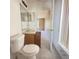 Bathroom features a toilet, vanity, and mirror at 323 Miami Ln, Kissimmee, FL 34759