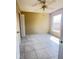 Bedroom featuring a tile floor, ceiling fan, and window at 323 Miami Ln, Kissimmee, FL 34759