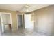 Bedroom featuring tile floors, ceiling fan, walk-in closet, and bathroom access at 323 Miami Ln, Kissimmee, FL 34759