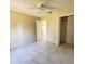 Bedroom with tile flooring, ceiling fan, and closet at 323 Miami Ln, Kissimmee, FL 34759