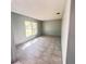 Bedroom featuring a window providing natural light with tile flooring at 323 Miami Ln, Kissimmee, FL 34759